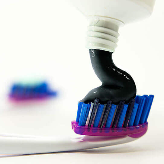 charcoal toothpaste applied on toothbrush